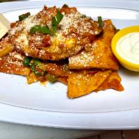 Chilaquiles · Mexican chilaquiles are made with a fried tortilla and a tomato sauce topped with fried eggs...