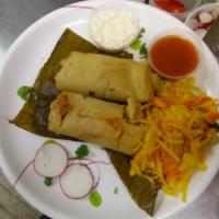 2 Fried Corn Tamales · Dough wrapped around a filling and steamed in a corn husk or banana leaf.