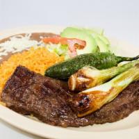 Carne Asada Specialty · Skirt steak with rice, bean, salad and tortillas.