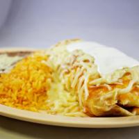 Burrito Suizo · Contains lettuce, tomato, onion, cheese, beans and sour cream, topped with ranchero sauce an...
