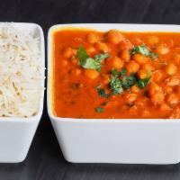 Chana Masala · Chickpeas slowly simmered with onions, tomatoes and spices. Served family style with rice. V...
