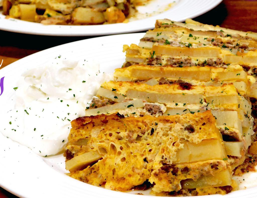 Musaka · Sliced potatoes baked in a ground beef sauce and then smothered in a thin white sauce.