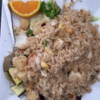 32. Pineapple Fried Rice · Pan fried rice with egg, pineapple, chicken, prawns, yellow onions, raisins and cashew nuts.