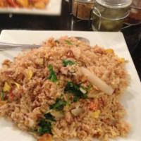 33. Fried Rice · Pan fried with eggs, yellow onions, tomatoes and green onion.