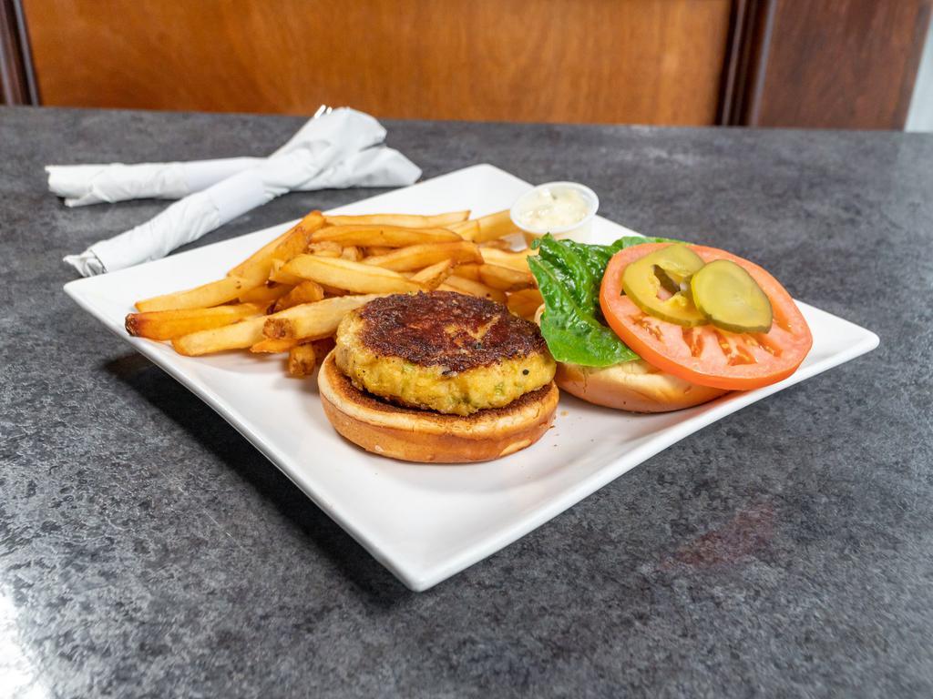 Crab Cake Sandwich · Broiled lump crabcake sandwich on a brioche roll served with lettuce, tomato, onion tartar sauce and french fries.