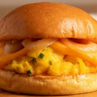 The Scramble · Cage free egg cheddar cheese, grilled onion, chive, spicy mayo, warm brioche bun.