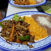 Steak Fajitas · Rice, beans, guacamole, tortillas