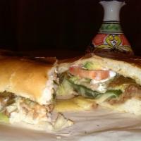 Vegetariana Torta · Filled with beans, rice, lettuce, tomato, onion, cilantro, and avocado.
