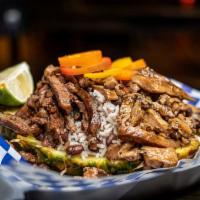 Jerk Pineapple Bowls · Seasoned jerk rice and beans, topped with diced sweet mini peppers, served in a half carved ...