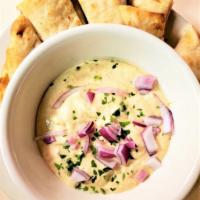 Hummus Alla Marx · Blended Chickpeas, Tahini, Garlic, Olive Oil, Lemon, and Greek Spices Served with Grilled Pi...