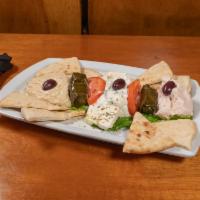 Pikilia Platter · Vegetable Dolmades, Tzatziki, Tarama, Hummus, Feta Cheese, and Olives Served with Grilled Pi...