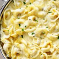 Tortellini Alfredo · Served with salad, bread and butter and Romano cheese.