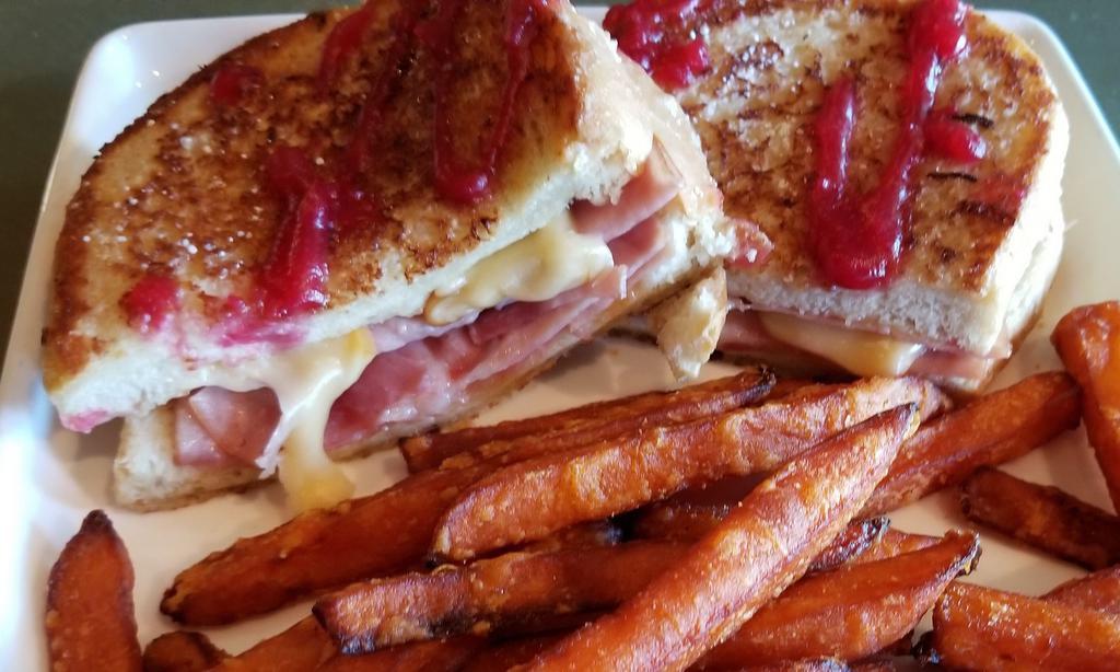 The Full Monte Cristo · We're letting it all hang out with this one! French-toasted, grilled sourdough with Honey baked thinly sliced ham and a gouda/swiss cheese combo make this a decadent treat of a meal. Served with Sweet Potato Fries