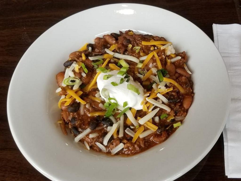 Flashpoint Chili · Chilly? Chili! Call the fire department! No emergency, just great, quick food, and they deserve something tasty. This chili is spicy, but it's not too hot. It's got ground beef, black beans and pinto beans, all mixed into a delicious blend of onions, garlic, tomato and spices, and topped with sour cream, cheddar jack cheese and scallions.