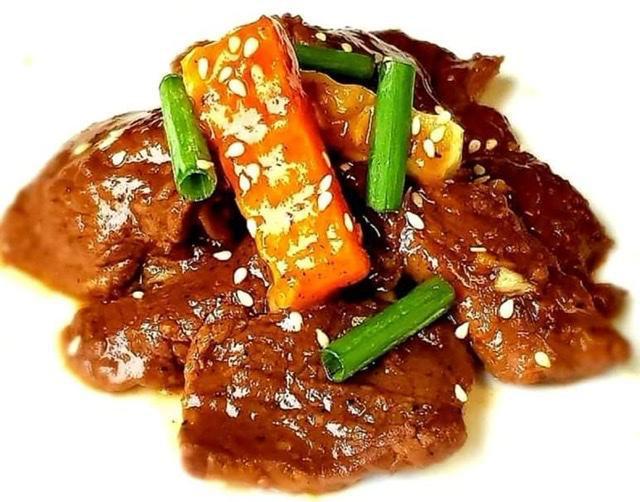 Korean Beef · Thin slices of marinated beef on a sweet and spicy sauce with carrots and  chayote topped w/ sesame seeds and scallions.