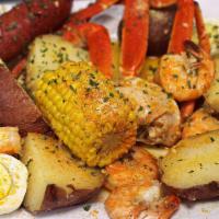 Bj’s Snow Crab Bag · Jumbo Snow crab cluster, smoked link sausage, 6 jumbo shrimp, 1 egg, 2 potato halves, and co...