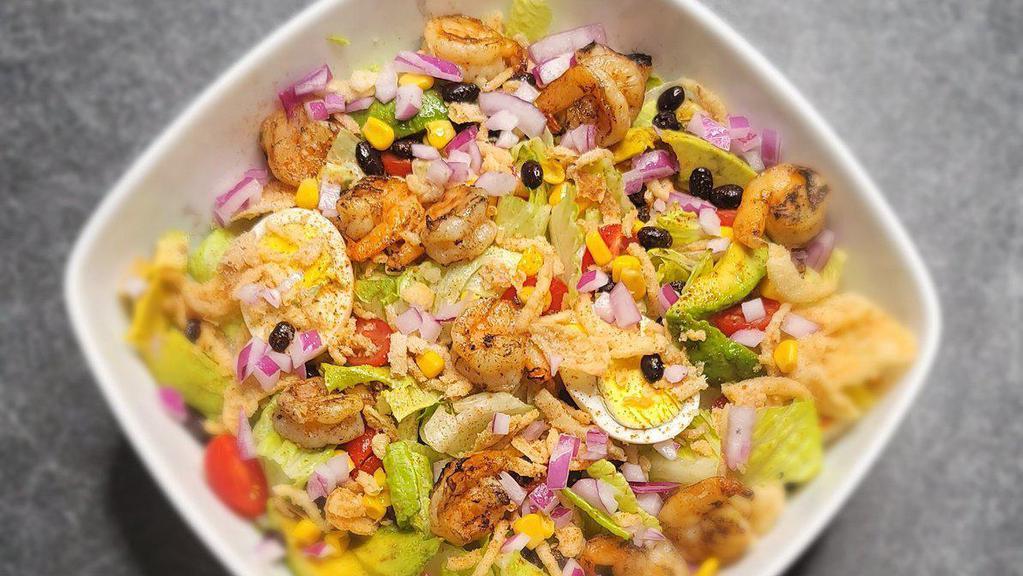 Shrimp Southwestern Salad · Grilled shrimp, mixed lettuce leaves, tomatoes chopped, avocado, red onion, corn, french onions, egg, and black beans. Recommended with homemade spicy honey-lime dressing.