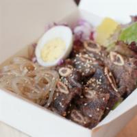Galbi cupbop · Thin sliced beef short rib marinated with soy base sauce , rice, clear noodle, lettuce, spri...