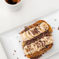 Banana Toast · Local flax bread toasted golden and topped with creamy peanut butter, organic sliced bananas...