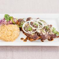 Mole Enchilada · 3 chicken enchiladas made with traditional Oaxaca mole sauce, rice and salad. Topped with qu...