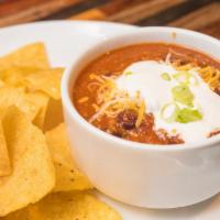 Beef Chili Bowl & Chips · Beef Chili topped with Sour Cream, Cheddar Cheese, and Green Onions. Served with a side of T...
