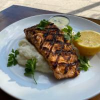 Grilled Atlantic Salmon · Served over Mashed Potatoes. Caper Lemon Butter Sauce on the side.