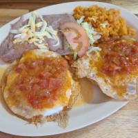 Huevos Rancheros / Over easy eggs with sauce · Includes rice and Beans