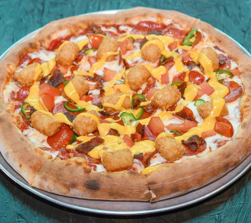 Mary Jane Pizza · Red tomato base topped with mozzarella cheese, pepperoni, bacon, jalapenos, fresh tomatoes and tater tots, then drizzled with nachos.