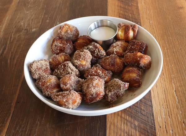 Cinnamon Sugar Pretzel Bites · A sweet alteration to our original pretzel bites. 
Brushed with butter, tossed in cinnamon sugar, great for sharing.
Served with house-made sweet vanilla dip. Vegetarian