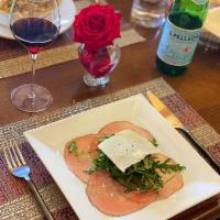 Carpaccio · Thinly sliced beef tenderloin with arugula, shaved Reggiano Parmigiano and lemon vinaigrette...