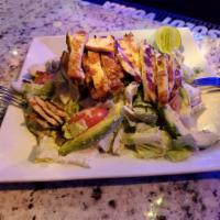 Caesar con Pollo Salad · Caesar salad topped with grilled chicken.