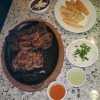 (2) Persons Parilladas  · Served with 3 sides. Steak, pork chops, chicken, chorizo, morcilla, intestines and chimichur...