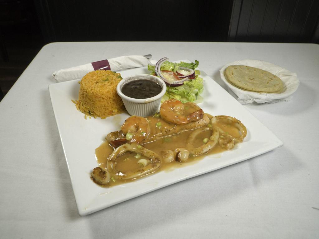 Mariscos a La Plancha Combo · Grilled shrimps, salmon, scallops, calamary tossed with house sauce, rice, beans and salad.