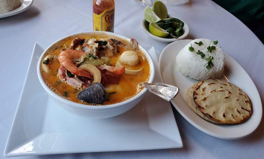 Sopa de Mariscos · Seafood soup, seasoned shrimps, clams, squid, scallops, crab and fish fillet and 2 tortillas.