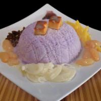 Halo-Halo · Taro snow, jack-fruit, coconut strings, red and white beans, flan on top and condensed milk.