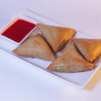 Samosas · Vegetarian. Hand-made wheat flour wraps fried and filled with potatoes, onions, and spices s...