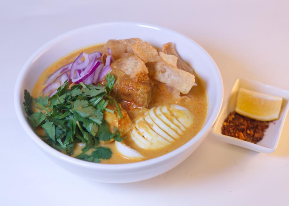 Ohn-No Khao Swe · Coconut chicken curry noodle soup.
A rich and creamy bisque with flour noodles and fried won ton. Served with chicken, onions, turmeric powder, and paprika, garnished with onions, cilantro, and fried wonton lemon. Vegetarian option available. Vegetarian option available.
Vegan option available.
Gluten-free option available.