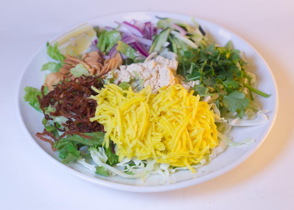 Mango Salad · Pickled mango with fried garlic, cabbage, red onions, cucumber, cilantro, yellow bean powder and fried onions, onion oil and dried shrimp powder on a bed of romaine lettuce. Vegetarian option available. Gluten-free.