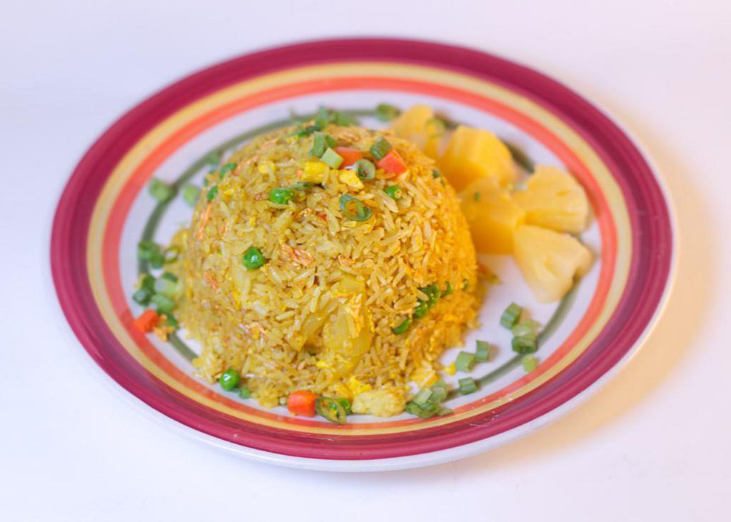 Pineapple Fried Rice · Choice of jasmine or brown rice with pineapple, green beans, carrots, egg, onions, scallions, soy sauce, and turmeric. 
Vegan option available.
Gluten-free option available.