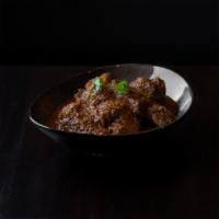 Burmese Style Lamb Curry · Poached diced lamb simmered in lemongrass, potatoes, curry powder, onions, ginger, garlic, m...