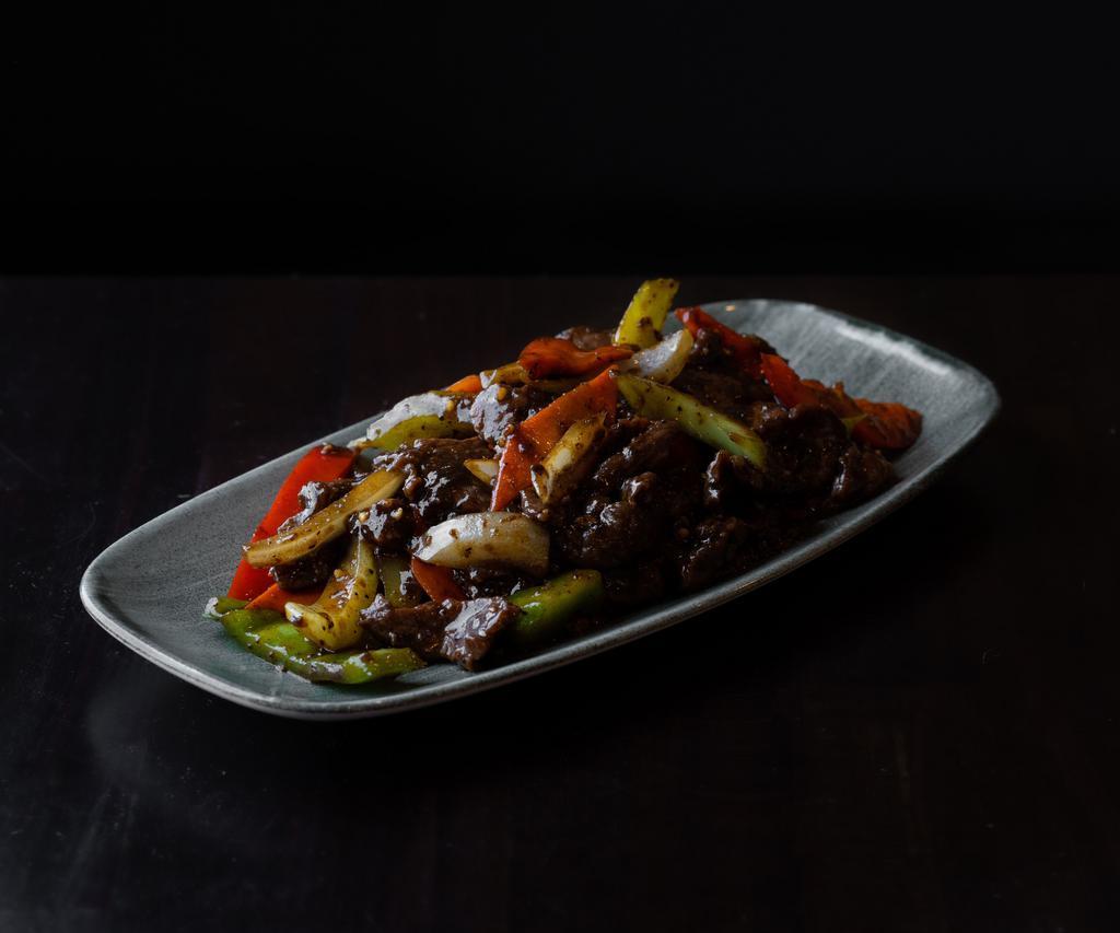 Black Pepper Lamb · Marinated lamb with onions, red and green bell peppers, celery, carrots, oyster sauce, garlic scallions, white wine, black bean sauce, soy sauce, and black and white pepper.