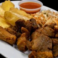 Yuca Con Chicharron · Broiled cassava with fried pork served with marinated cabbage, lettuce and tomatoes.