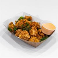 Basil Popcorn Chicken · Includes gluten. Lightly coated popcorn chicken. Extra sauce for an additional charge.