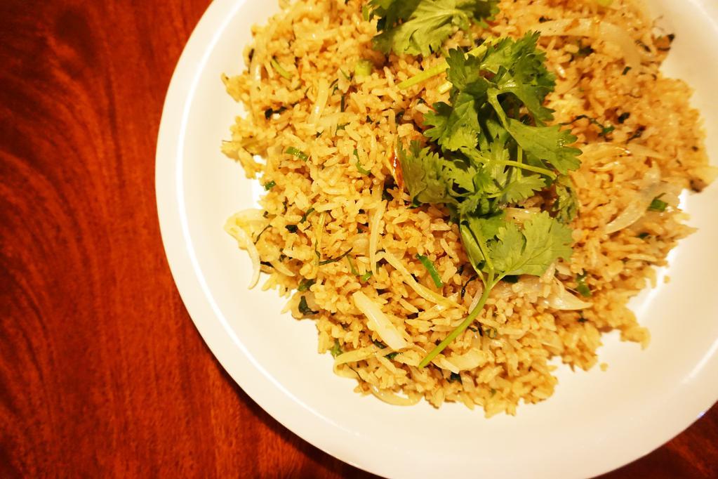 Crab Basil Fried Rice (Com Chien Cua) · Our signature fried rice is made to order with jasmine rice stir fried with yellow onions, thai basil and crab claw meat.