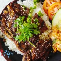 Korean spare ribs  · Marinaded Korean beef spare ribs grilled topped with sesame seeds and onions, served over a ...