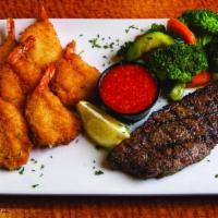 Steak & Giant Shrimp · Hand-cut, 6oz. steak paired with six golden fried shrimp. Served with fresh cut lemon, house...