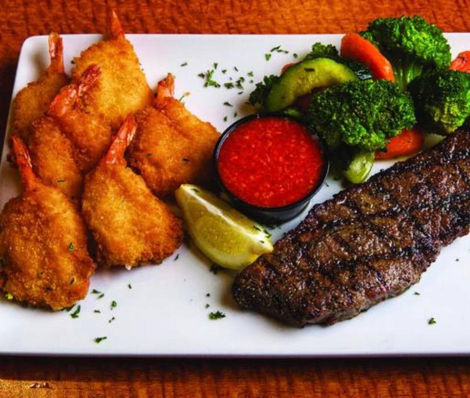 Steak & Giant Shrimp · Hand-cut, 6oz. steak paired with six golden fried shrimp. Served with fresh cut lemon, housemade cocktail sauce and a choice of your favorite Sizzler side. 
