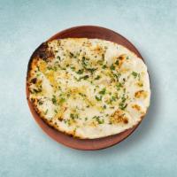Garlic Naan  · Leavened refined wheat  flatbread baked in a tandoor clay oven and topped with garlic.