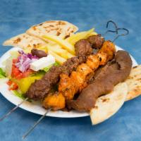 Combo Platter · 1 skewer of souvlaki, skewer of chicken, slices of gyro with lemon potatoes, Greek salad and...