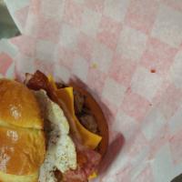 KC's Special Burger · 1/2 lb. bricket burger, topped with a sausage patty, hickory smoked ham and bacon, fresh coo...